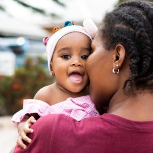 Woman carrying her baby to illustrate fertility
